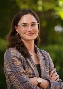 Dr. Leah Abrams, a woman with dark brown hair who is wearing glasses.